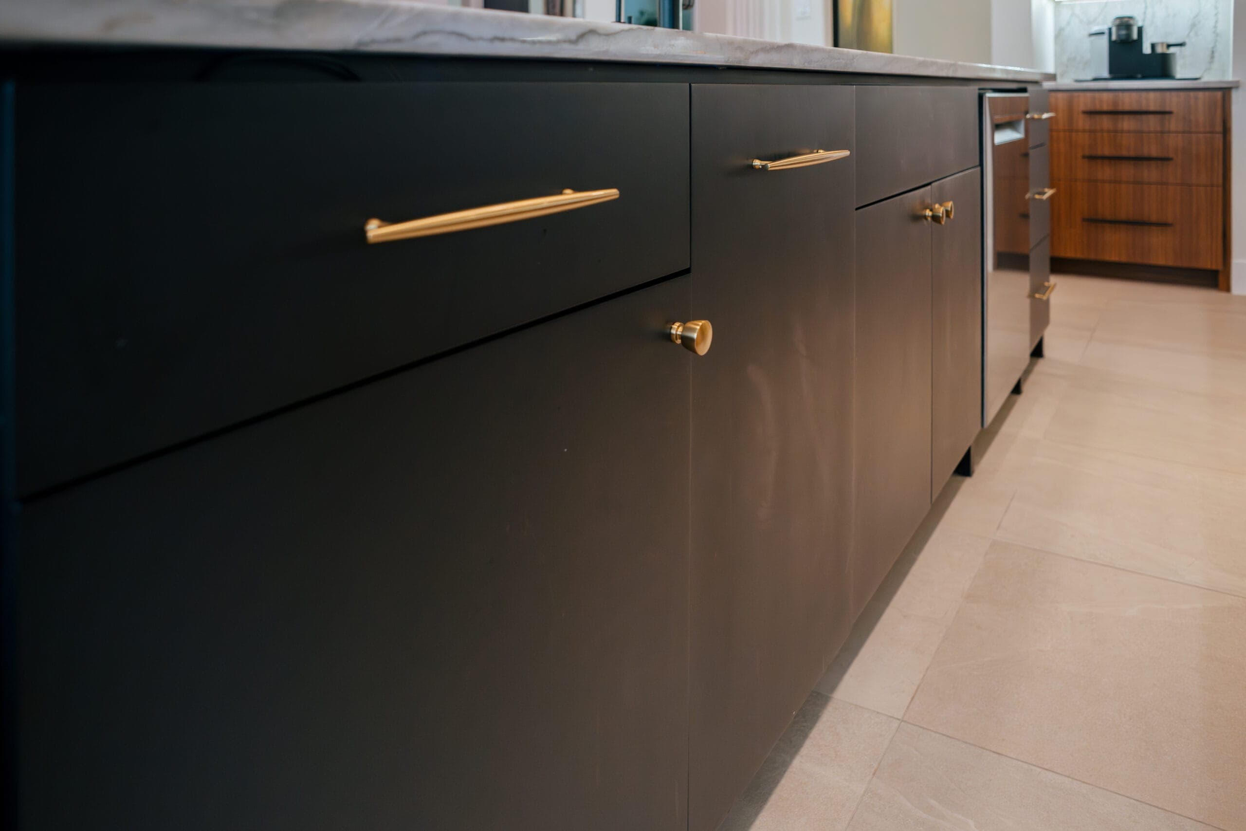 Matte black island panels with slim black and brass bar pulls