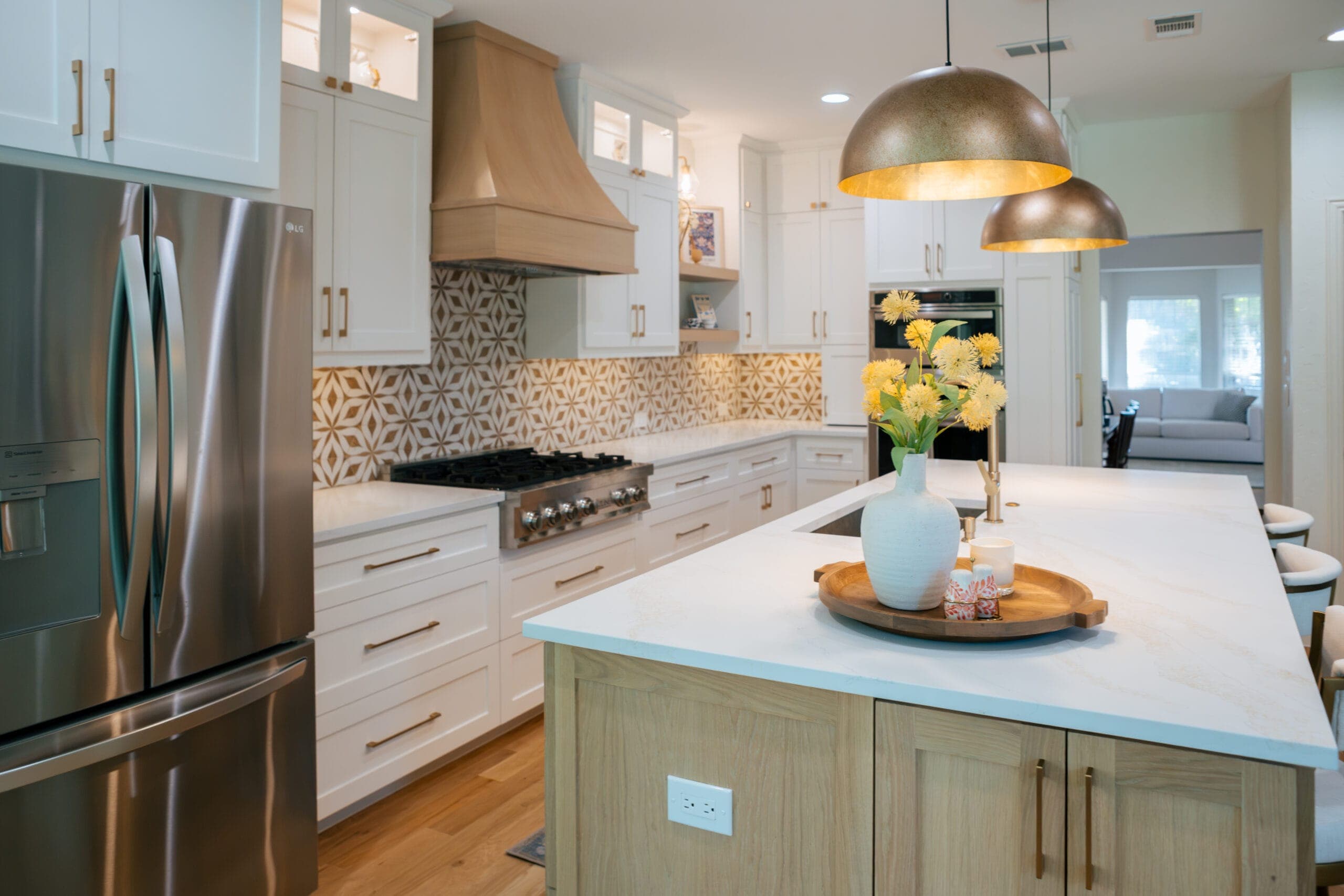 White shaker perimeter cabinets and stainless appliances surrounding a white oak island